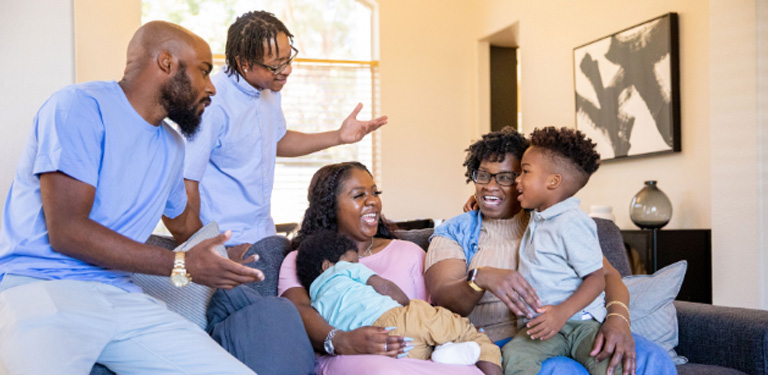 Image of extended family sitting and talking about CGD